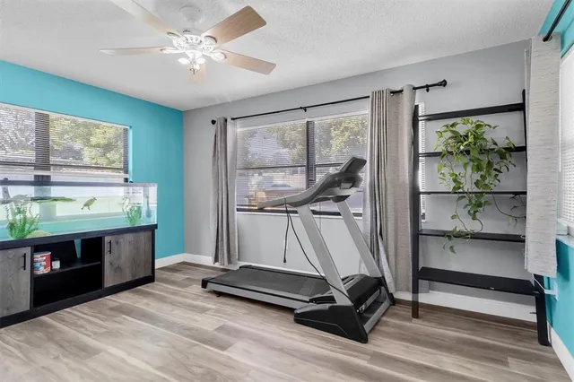 a room with gym equipment and a large window