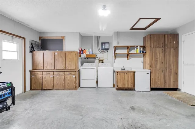 a kitchen with refrigerator and cabinets