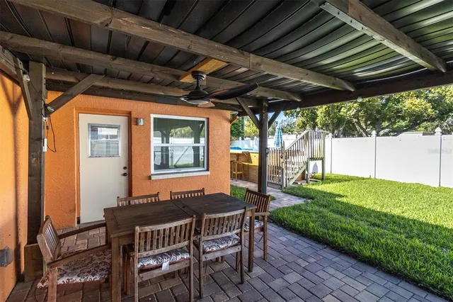a patio with wooden floors and outdoor seating