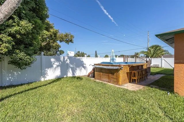 a view of a patio with table and chairs potted plants