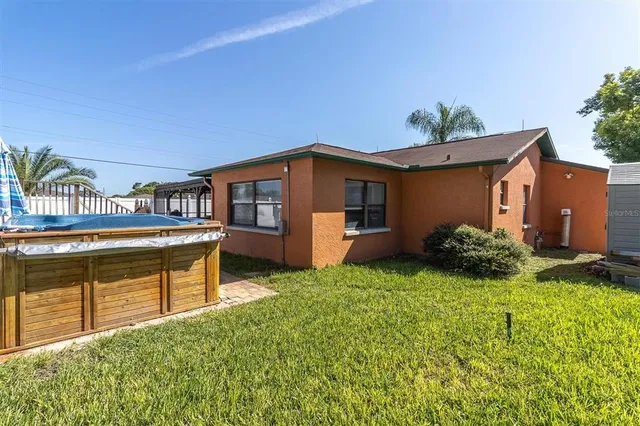 a view of a house with pool and chairs