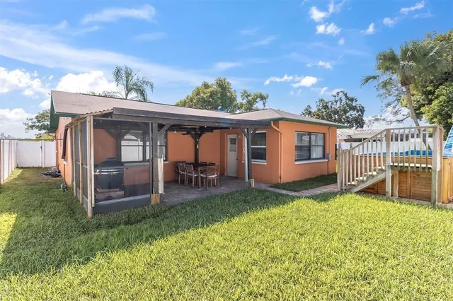 a view of a house with a yard and sitting area