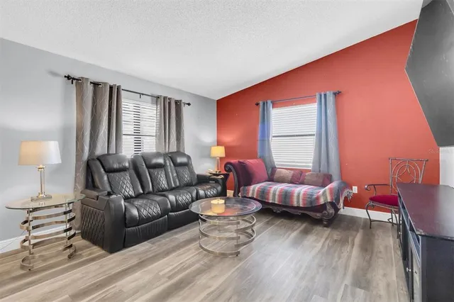 a living room with furniture and a large window