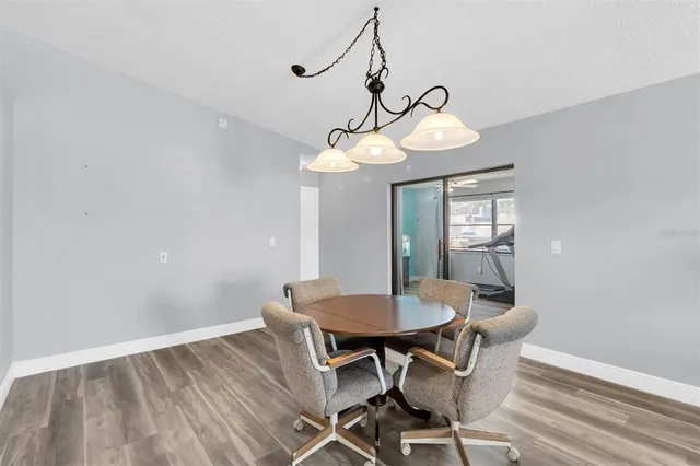 a view of a dining room with a table and chairs