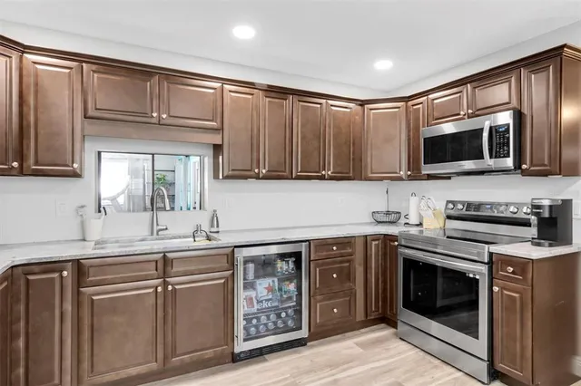 a kitchen with stainless steel appliances granite countertop a sink and stove top oven