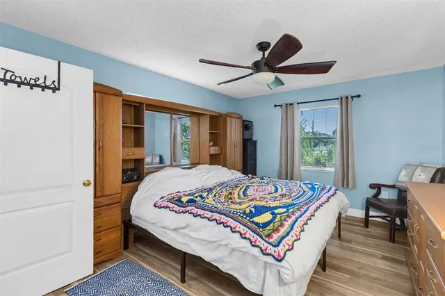 a bedroom with a bed and wooden floor