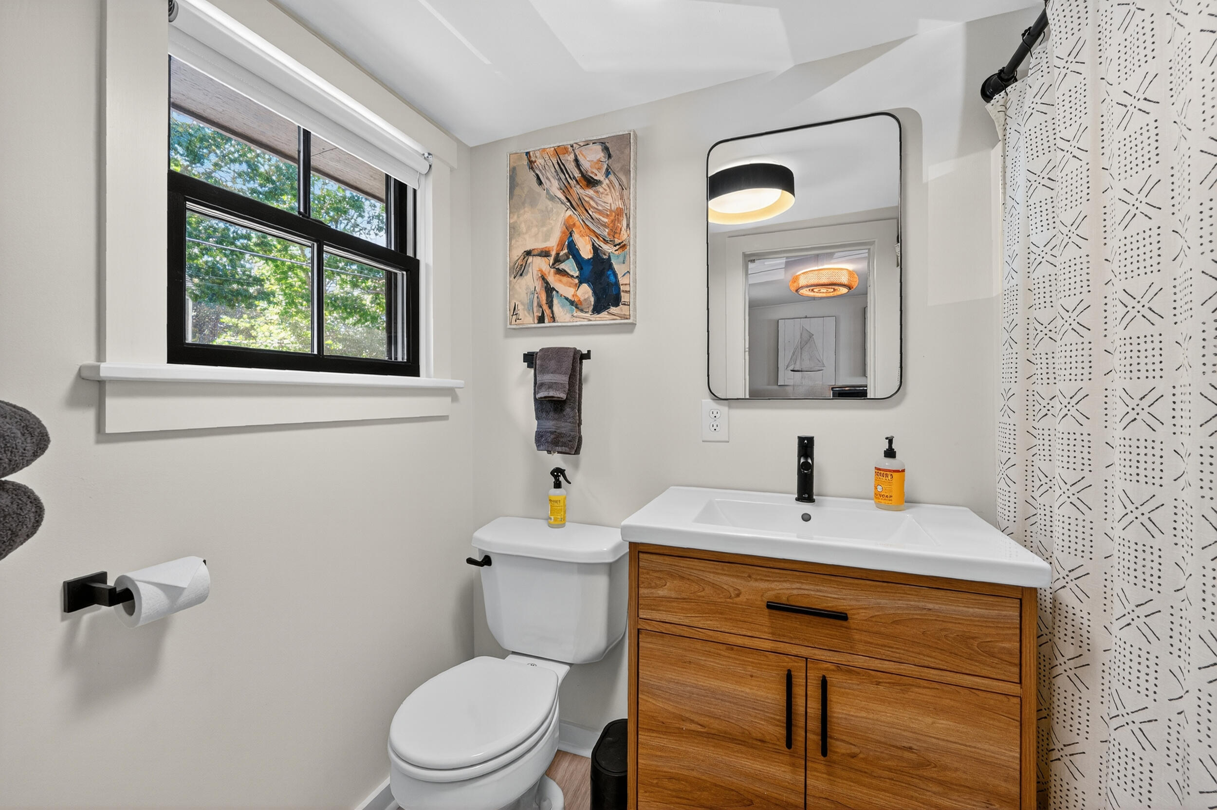 18 Great River Road Mashpee, MA 02649 - Photo 40 of 99 a bathroom with a toilet a sink a mirror and a window