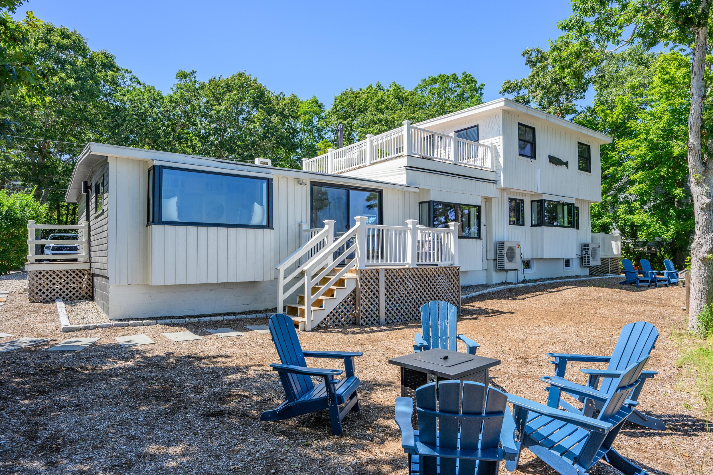 18 Great River Road Mashpee, MA 02649 - Photo 62 of 99 a front view of a house with swimming pool table and chairs