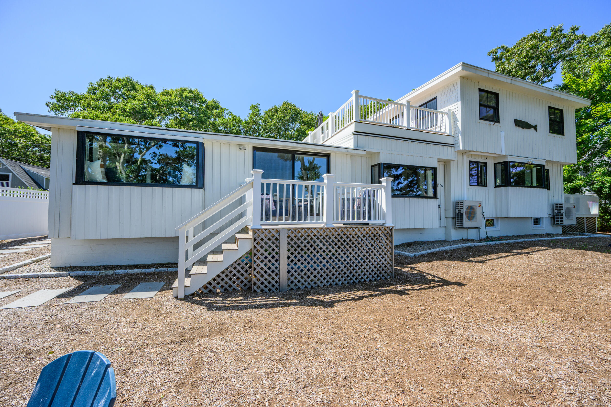 18 Great River Road Mashpee, MA 02649 - Photo 66 of 99 a front view of a house with a yard and garage