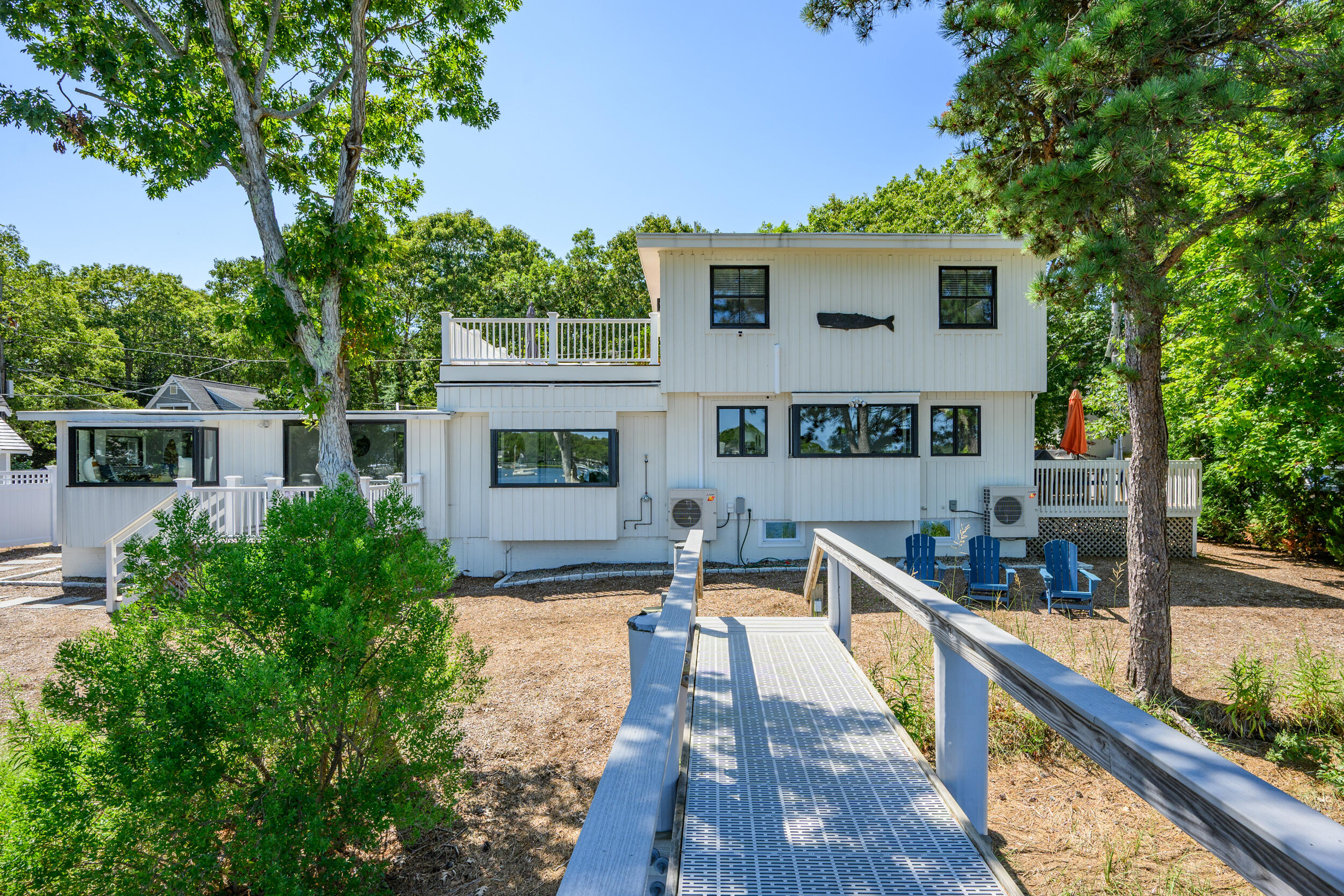 18 Great River Road Mashpee, MA 02649 - Photo 75 of 99 a front view of a house with swimming pool and sitting area