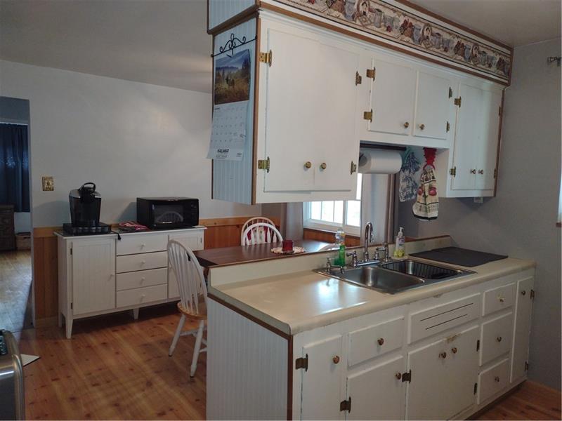 118 Sylvan Drive Lower Burrell, PA 15068 - Photo 7 of 14 a kitchen with granite countertop a sink a stove and cabinets