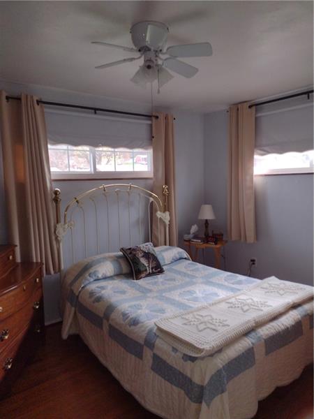 118 Sylvan Drive Lower Burrell, PA 15068 - Photo 9 of 14 a bedroom with a bed and a chandelier