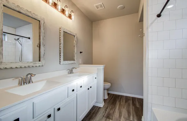 a bathroom with a double vanity sink and mirror