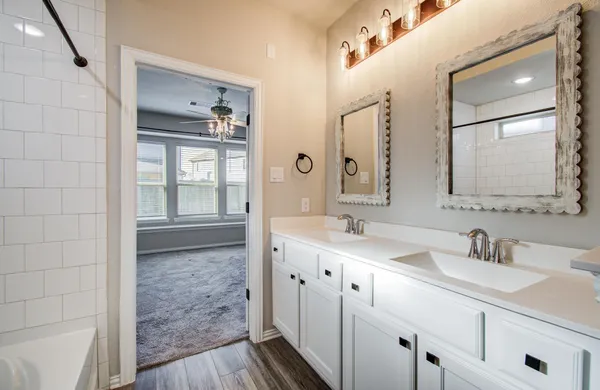 a bathroom with a double vanity sink and mirror
