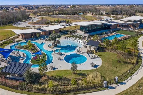 a view of a swimming pool with outdoor seating
