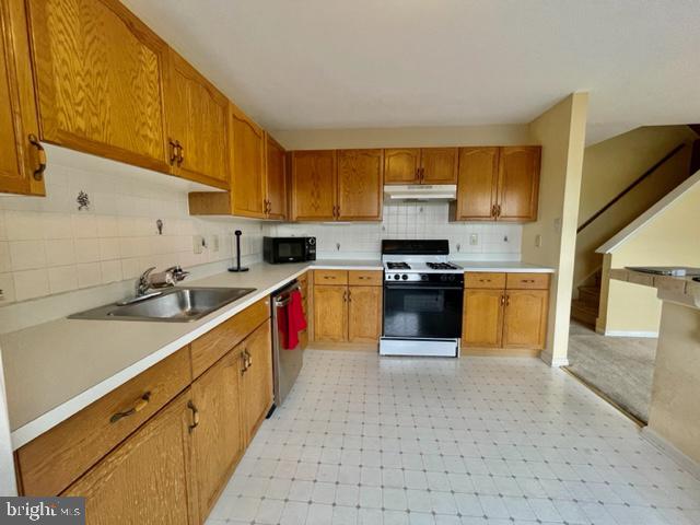 268 Ripka Street Philadelphia, PA 19127 - Photo 11 of 31 a kitchen with stainless steel appliances granite countertop a stove sink and cabinets