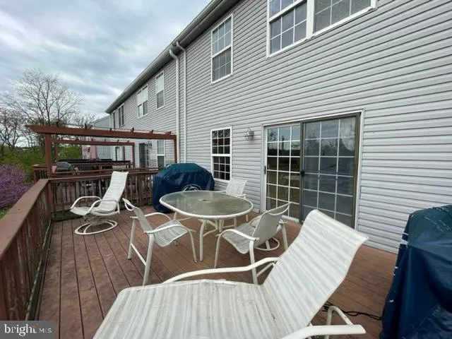 a view of balcony with wooden floor and fence