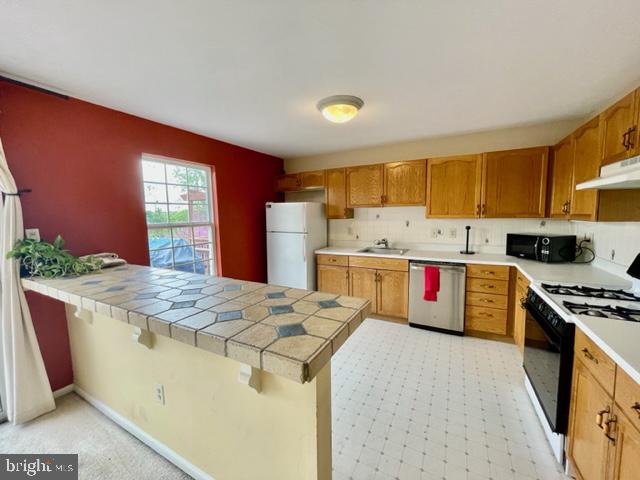 268 Ripka Street Philadelphia, PA 19127 - Photo 7 of 31 a kitchen with stainless steel appliances granite countertop a stove a sink and a refrigerator