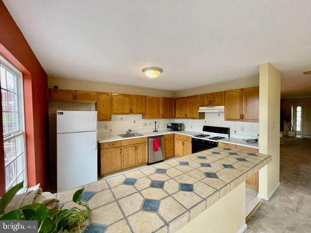 268 Ripka Street Philadelphia, PA 19127 - Photo 8 of 31 a kitchen with stainless steel appliances kitchen island granite countertop a refrigerator and a stove top oven