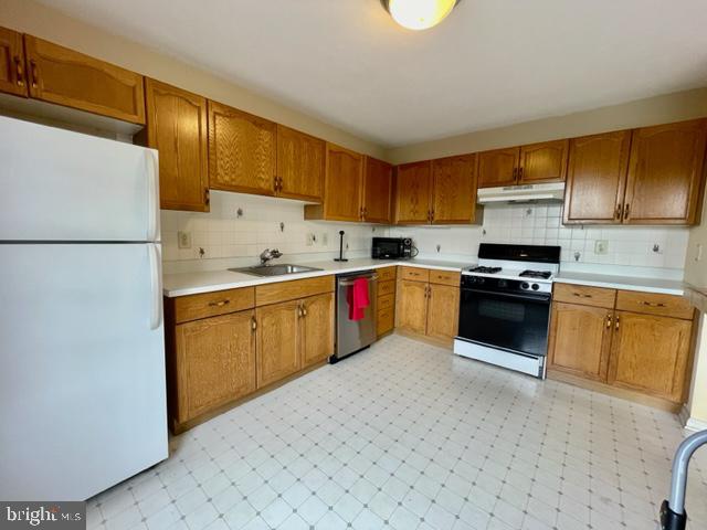 268 Ripka Street Philadelphia, PA 19127 - Photo 10 of 31 a kitchen with granite countertop a sink stainless steel appliances and cabinets