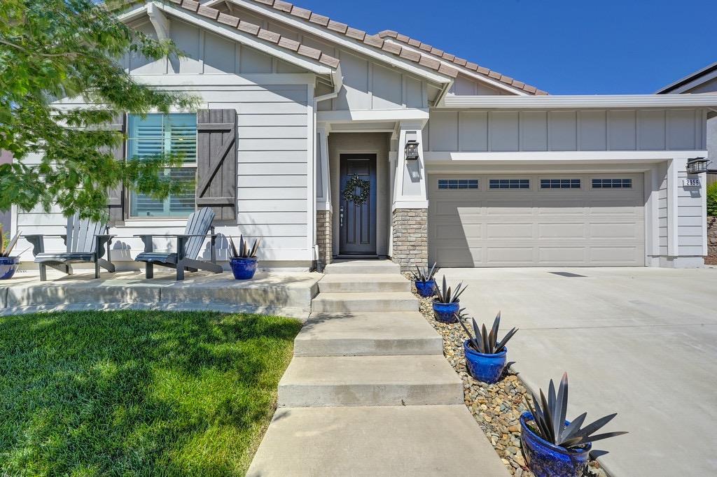 2956 Shady Acres Loop Rocklin, CA 95765 - Photo 1 of 1 a front view of a house with a garden and patio