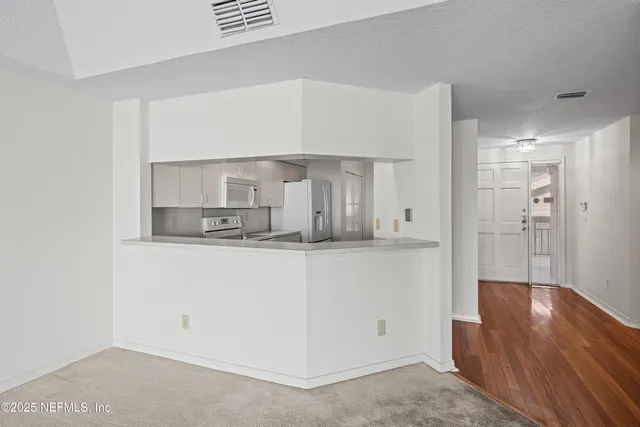 a kitchen with stainless steel appliances a refrigerator and cabinets