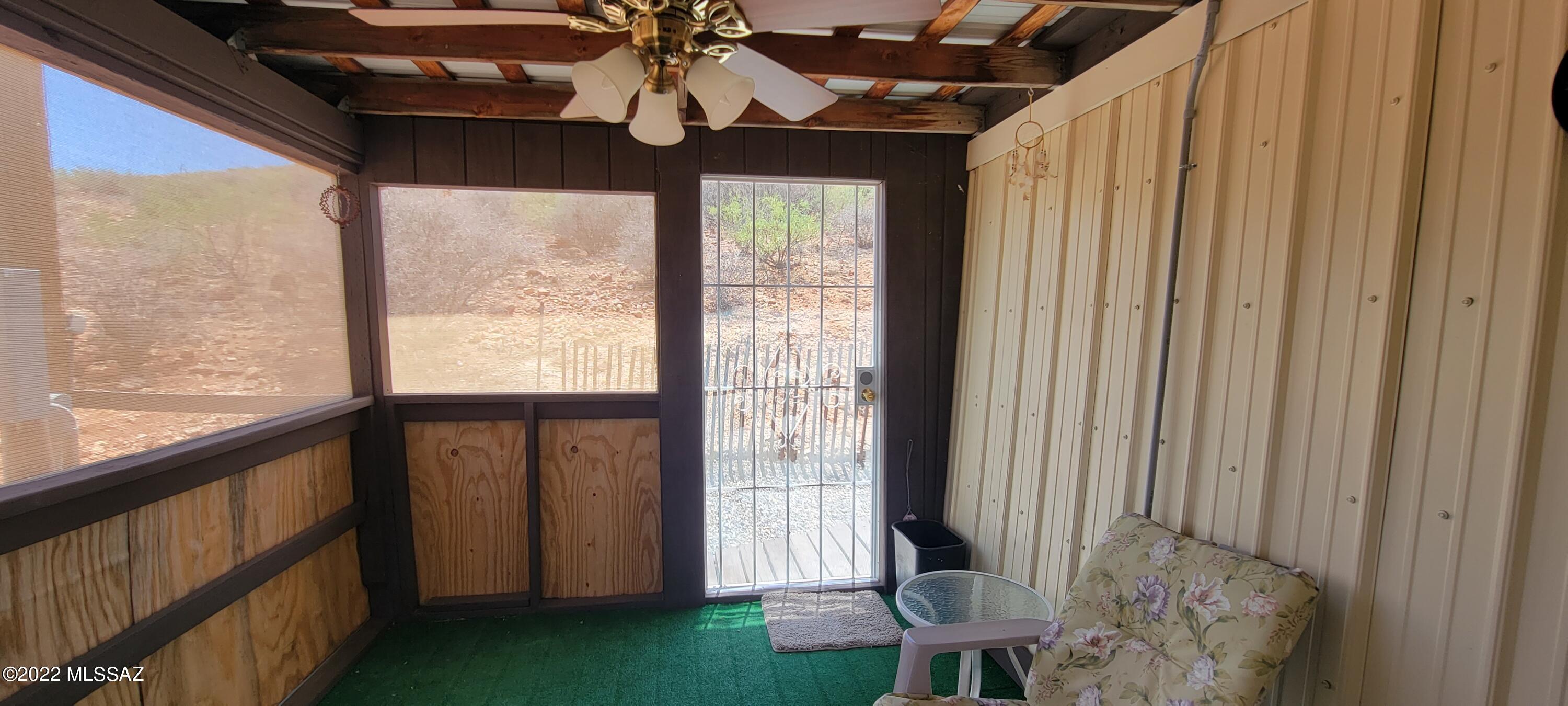 3399 Red Stag Road Pearce, AZ 85625 - Photo 17 of 47 a view of a porch with furniture and a window