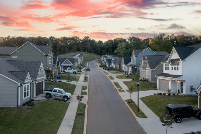 a view of a house next to a yard