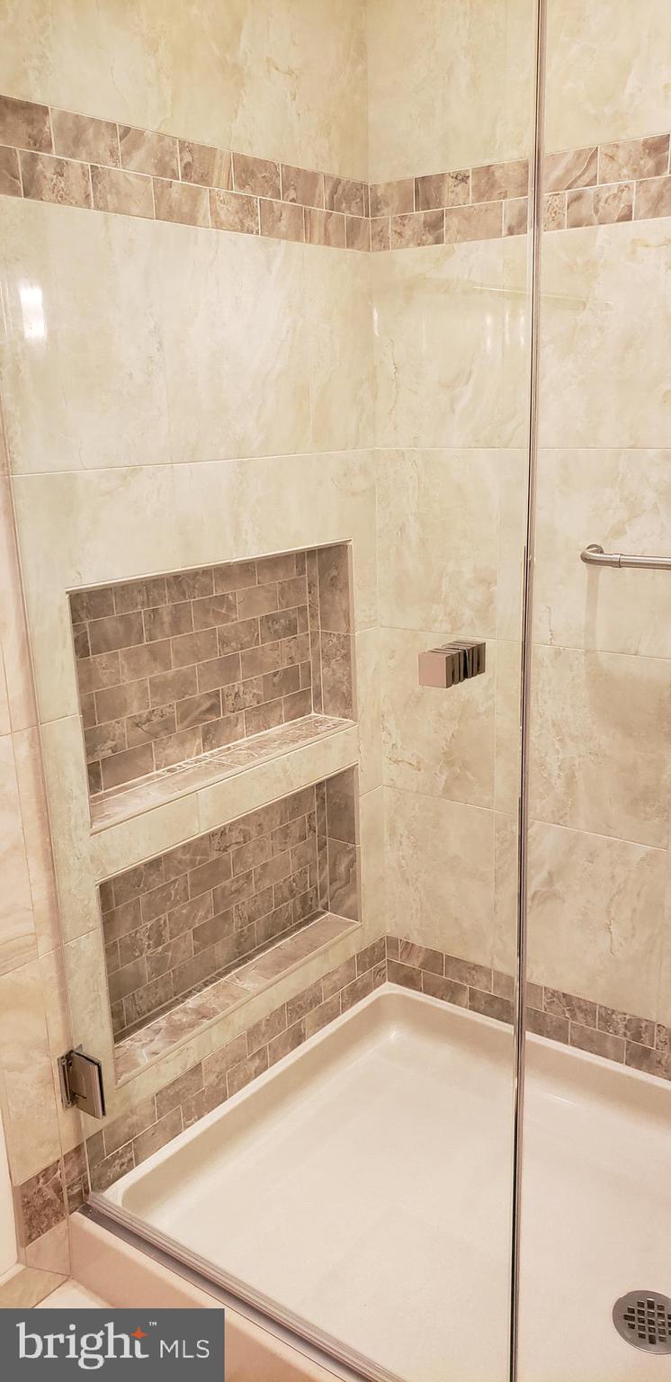 11503 Maple Ridge Road Reston, VA 20190 - Photo 92 of 94 Tiled niches with custom glass shower doors