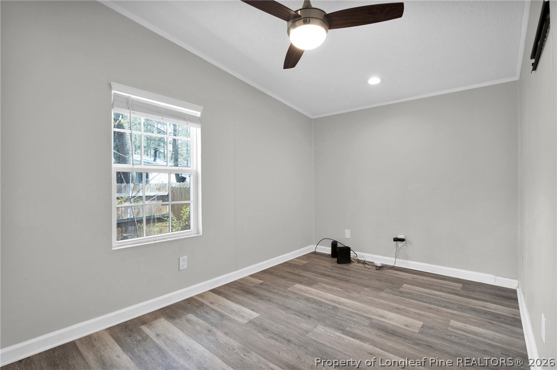 518 Inverary Drive Raeford, NC 28376 - Photo 20 of 30 a view of empty room with wooden floor and fan