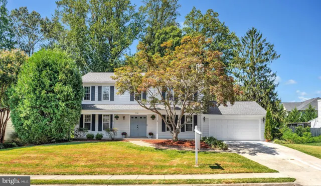 a view of a white house with a swimming pool and a yard