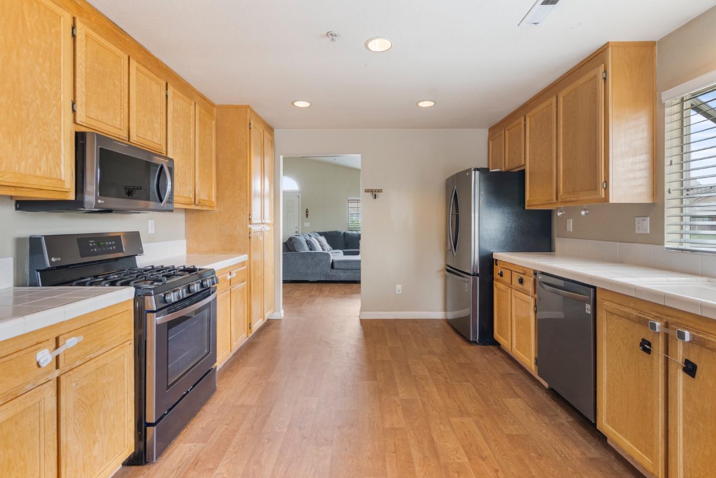 1001 Eagle Drive Salinas, CA 93905 - Photo 11 of 39 a kitchen with stainless steel appliances granite countertop a stove top oven a refrigerator a sink and dishwasher with wooden floor