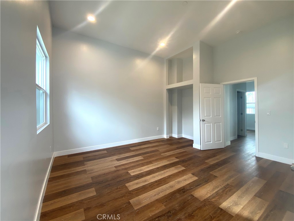 300 East Alhambra Road, Unit D Alhambra, CA 91801 - Photo 13 of 26 a view of an empty room with wooden floor and a window