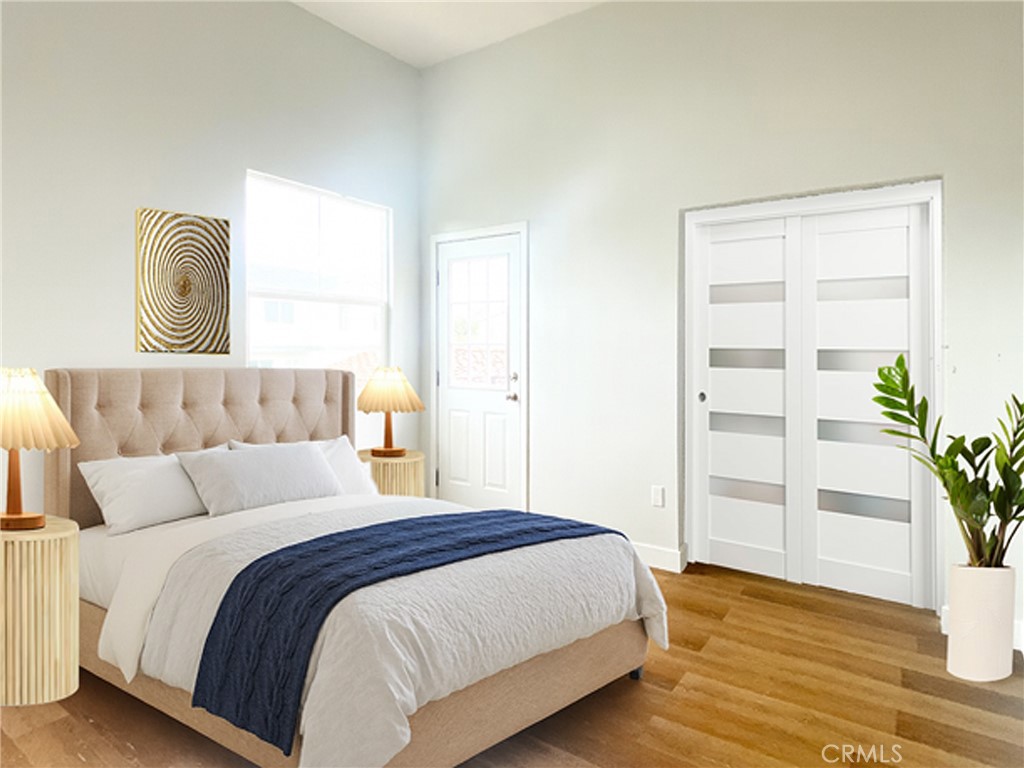 300 East Alhambra Road, Unit D Alhambra, CA 91801 - Photo 14 of 26 a bedroom with a bed and wooden floor