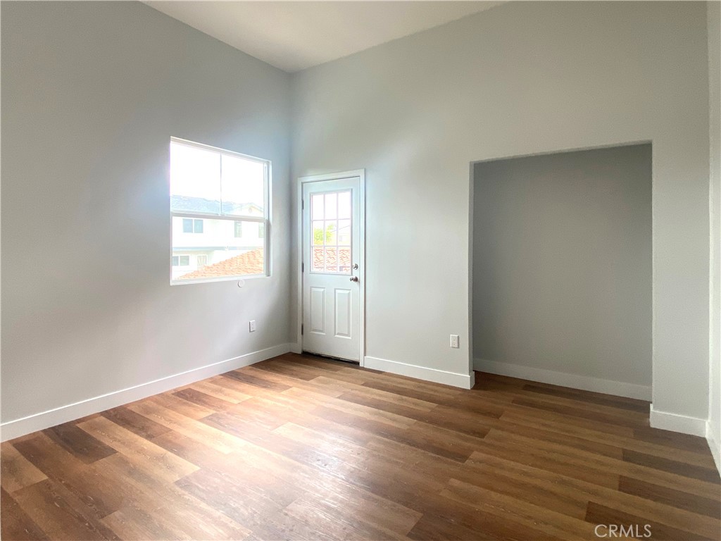 300 East Alhambra Road, Unit D Alhambra, CA 91801 - Photo 15 of 26 an empty room with wooden floor and windows