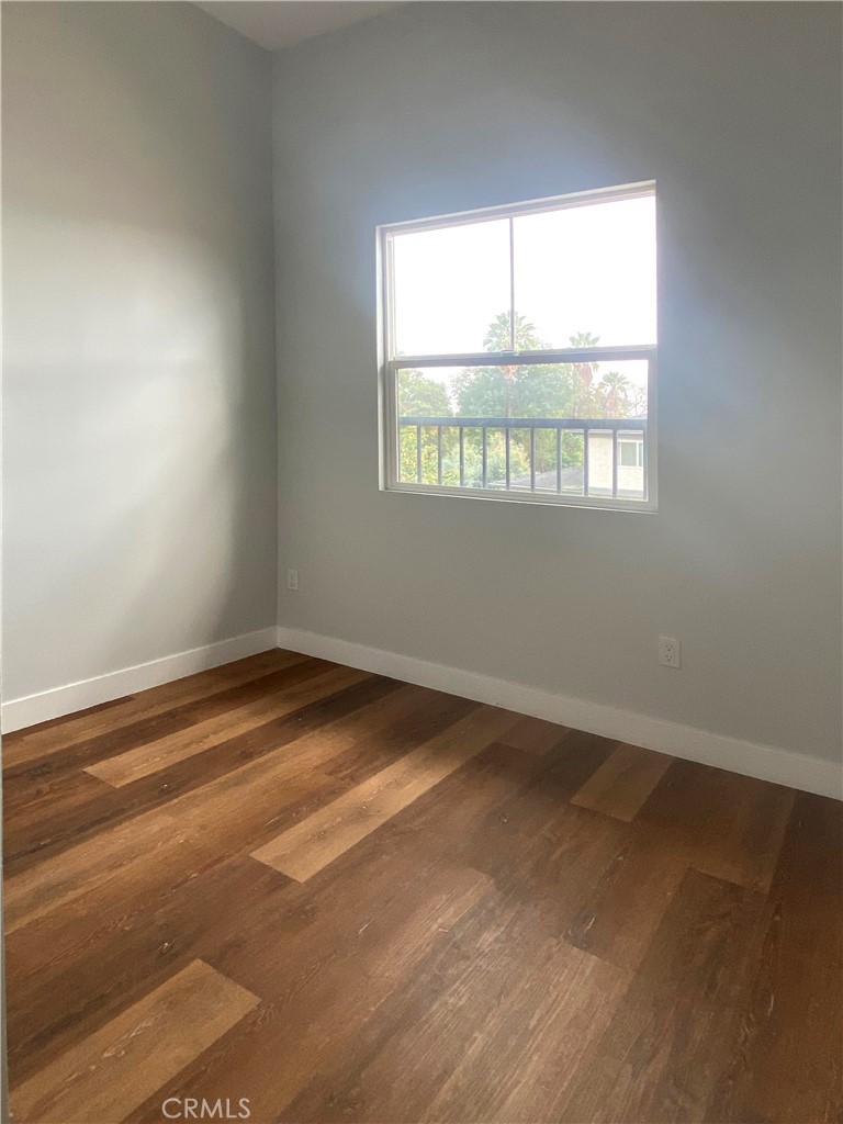 300 East Alhambra Road, Unit D Alhambra, CA 91801 - Photo 17 of 26 an empty room with wooden floor and windows