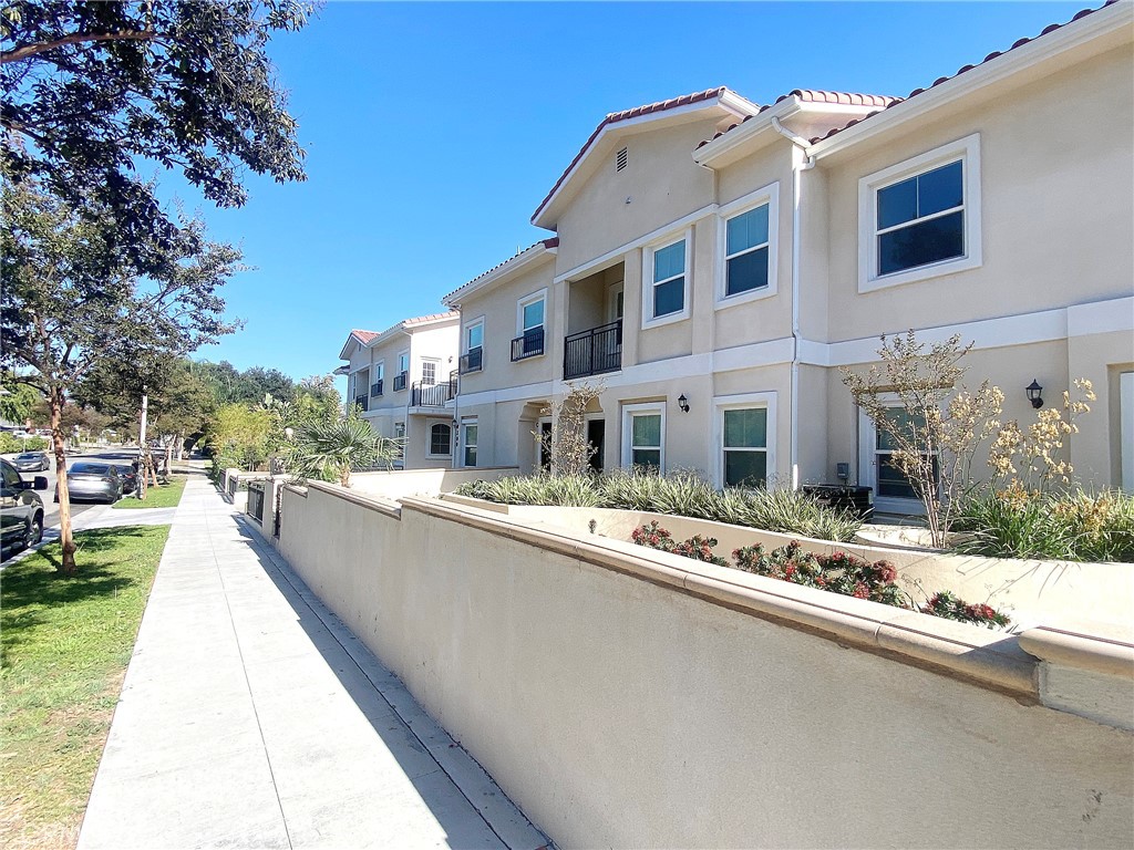 300 East Alhambra Road, Unit D Alhambra, CA 91801 - Photo 21 of 26 a front view of a house with a yard
