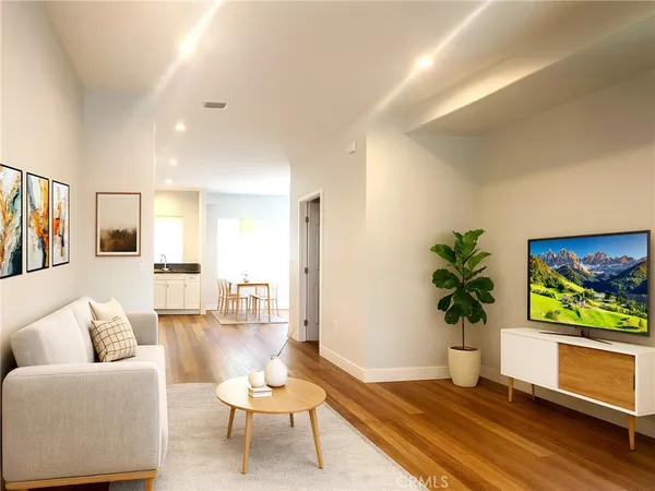 a living room with furniture and a potted plant
