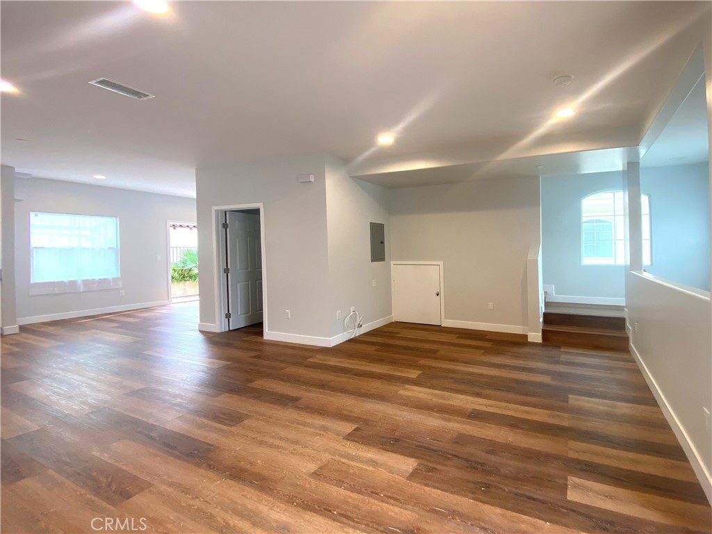 300 East Alhambra Road, Unit D Alhambra, CA 91801 - Photo 7 of 26 a view of an empty room with wooden floor and a window