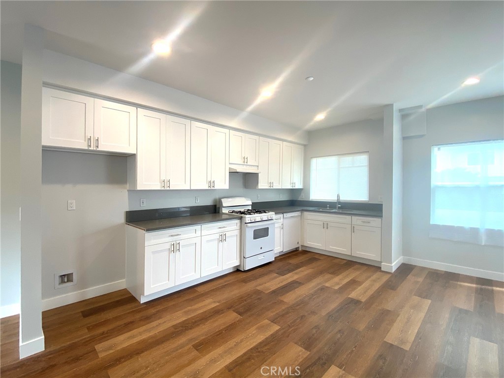 300 East Alhambra Road, Unit D Alhambra, CA 91801 - Photo 10 of 26 a kitchen with granite countertop white cabinets and white appliances