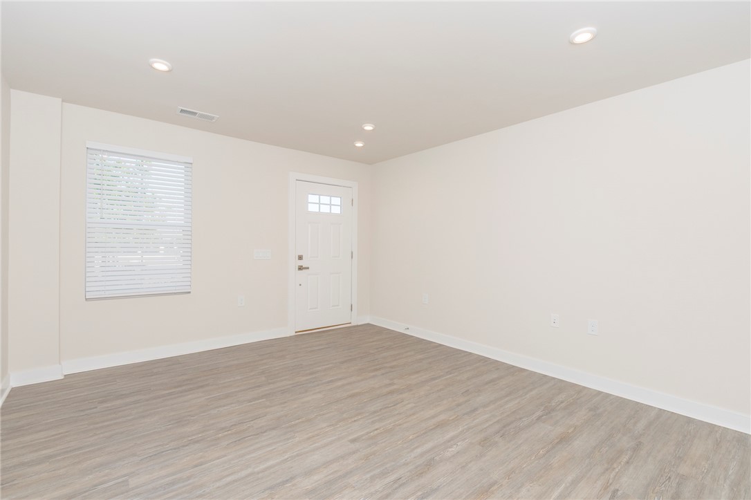 233 Scenic Road Anderson, SC 29621 - Photo 6 of 50 Laminate flooring graces this generous living space, offering both style and durability.