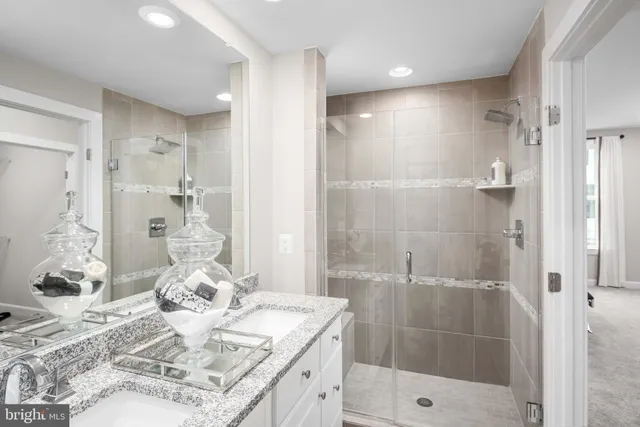 a bathroom with a granite countertop toilet sink and mirror