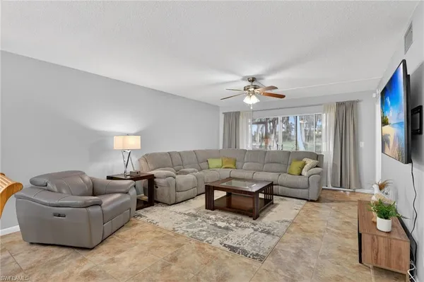 a living room with furniture and a large window