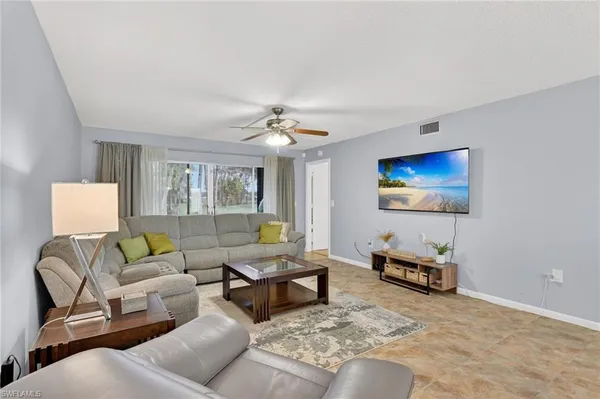 a living room with furniture and a flat screen tv