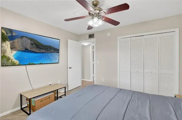a view of a workspace with furniture and a chandelier fan