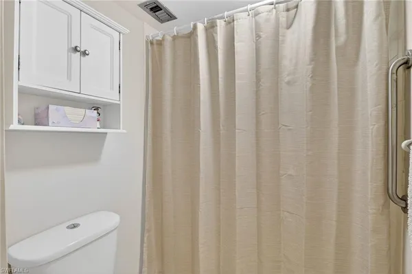 a bathroom with a shower curtain and a toilet