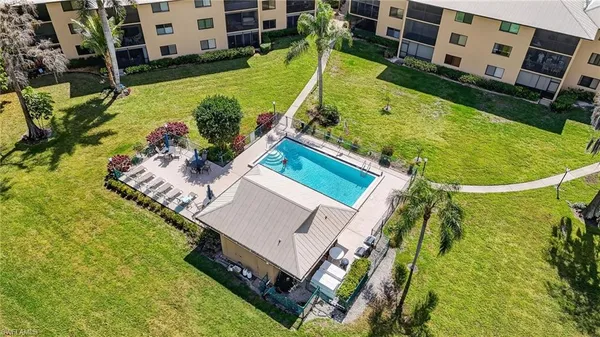 aerial view of a house with swimming pool and large trees