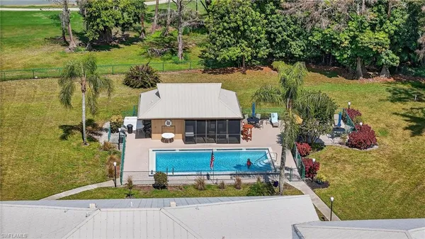 an aerial view of a house with swimming pool and patio