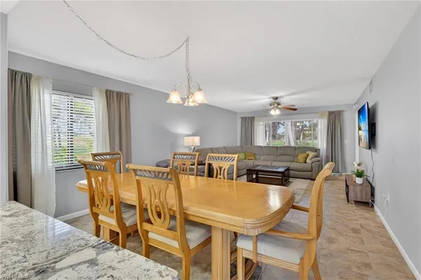 a view of a dining room with furniture and a chandelier