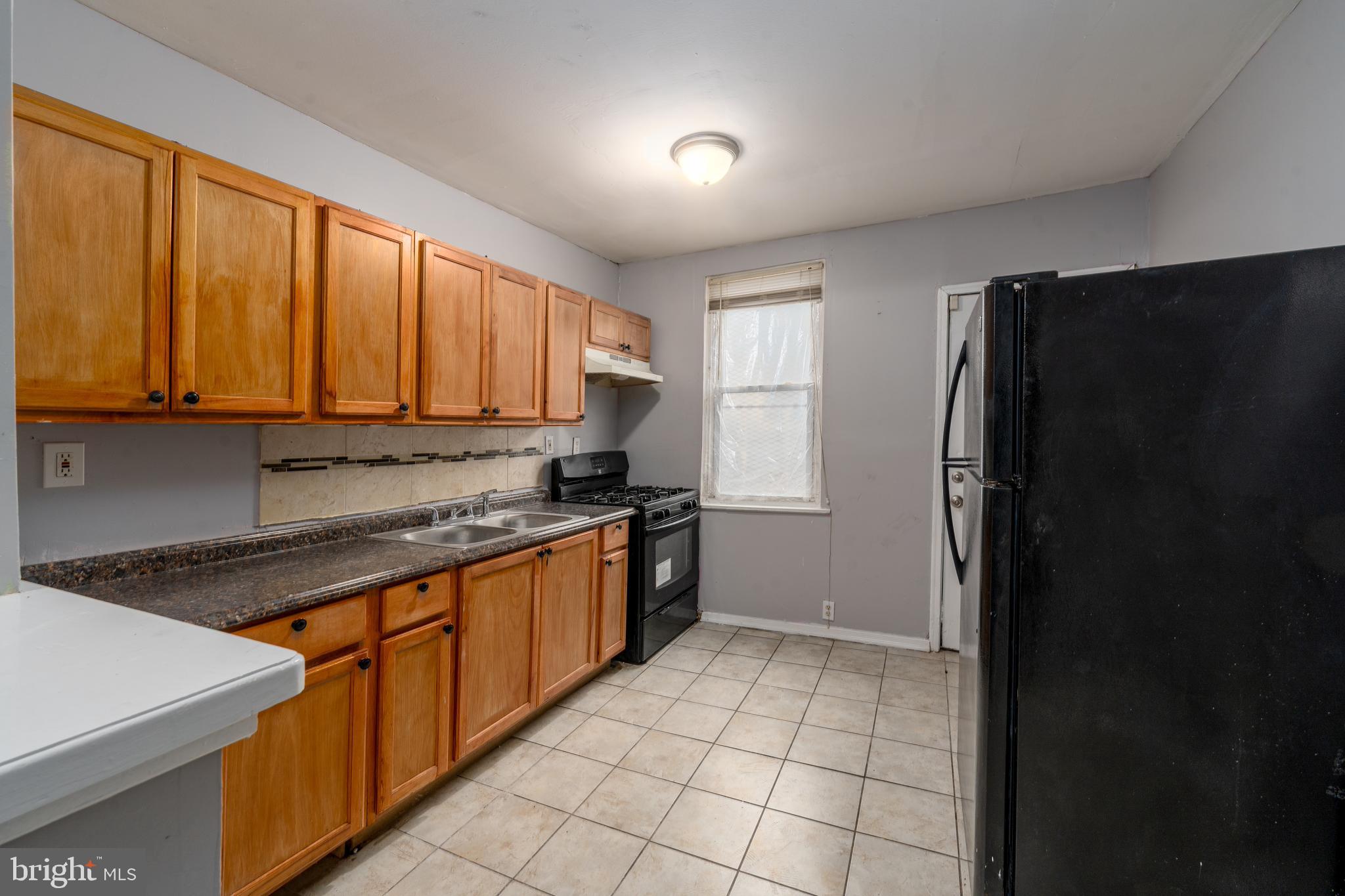 430 South Payson Street Baltimore, MD 21223 - Photo 12 of 29 a kitchen with stainless steel appliances granite countertop a refrigerator and a sink